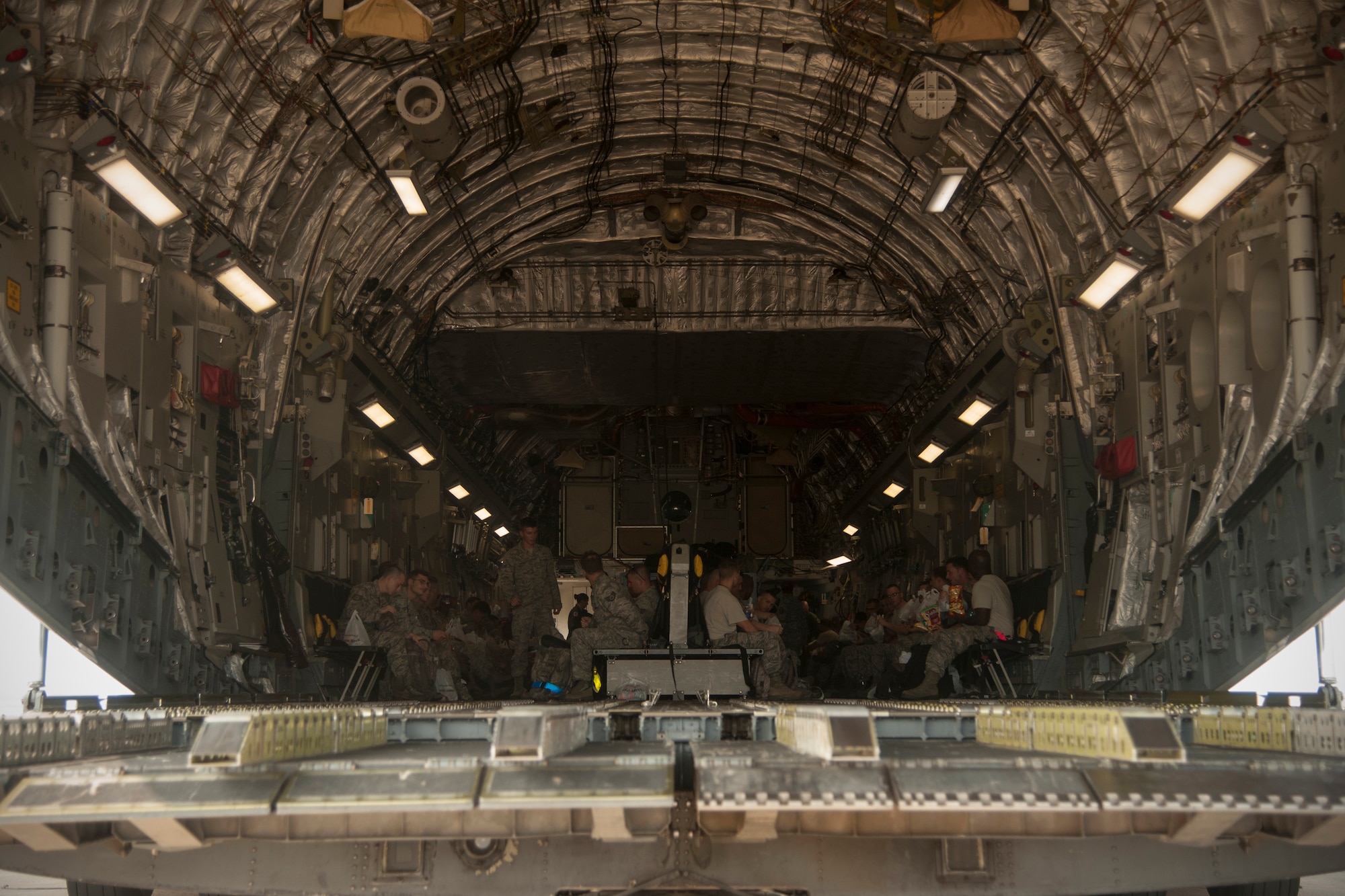 Wolf Pack Airmen await departure for RED FLAG-Alaska 14-3 inside a C-17 Globemaster III at Kunsan Air Base, Republic of Korea, Aug. 5, 2014. RF-A provides realistic training for deployed maintenance and support personnel in sustainment of large-force deployed air operations. (U.S. Air Force photo by Senior Airman Taylor Curry/Released)