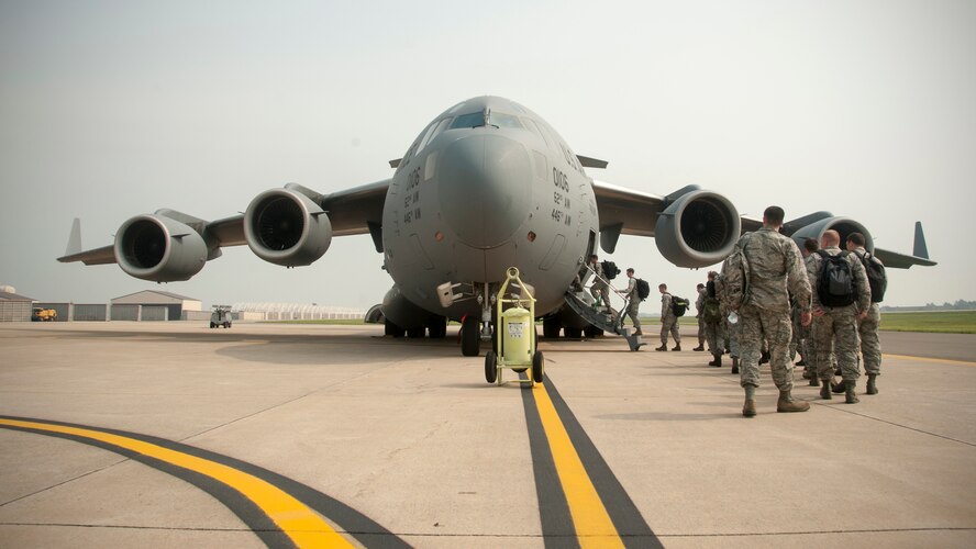 Wolf Pack Airmen board a C-17 Globemaster III departing from Kunsan Air Base, Republic of Korea, for RED FLAG-Alaska 14-3, Aug. 5, 2014.  RF-A is a Pacific Air Forces-directed field training exercise for U.S. and international forces flown under simulated air combat conditions. (U.S. Air Force photo by Senior Airman Taylor Curry/Released)