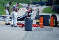 Wolf Pack Airmen clean up a simulated kerosene spill during an Emergency Management exercise at Kunsan Air Base, Republic of Korea, Aug. 11, 2014.  The EME was conducted to evaluate the Wolf Pack’s ability to react to a simulated emergency. (U.S. Air Force photo by Tech Sgt. Justin Snow/Released)
