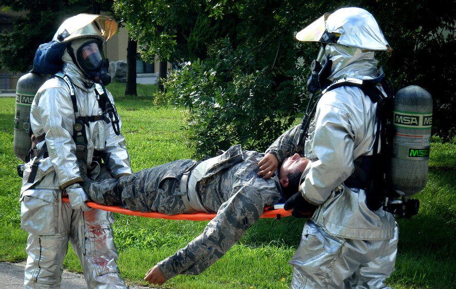 First responders assist simulated victims during an Emergency Management exercise at Kunsan Air Base, Republic of Korea, Aug. 11, 2014.  The EME was conducted to evaluate the Wolf Pack’s ability to react to a simulated emergency. (U.S. Air Force photo by Tech Sgt. Justin Snow/Released)