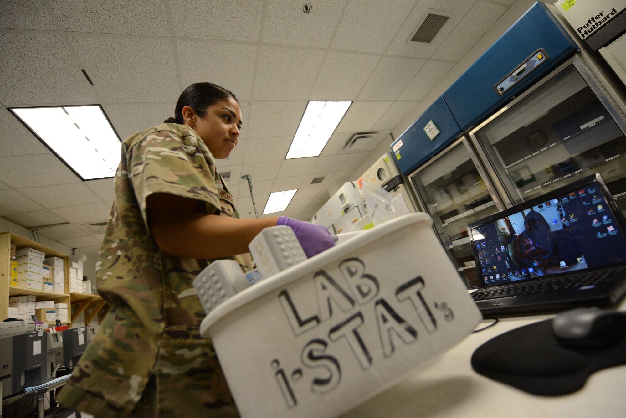 U.S. Air Force Senior Airman Kandie Ibarra, a lab technician assigned to the 455th Medical Support Squadron, Craig Joint Theater Hospital, Bagram Airfield, Afghanistan carries her I-stats tub as she makes her way to the trauma room after receiving an emergency call June 23, 2014. When responding to an emergency call, lab techs must be prepared to conduct on the spot chemistry results. Ibarra is deployed from Keesler Air Force Base, Miss. and a native of Blackfoot, Idaho. (U.S. Air Force photo by Master Sgt. Cohen A. Young/Released)