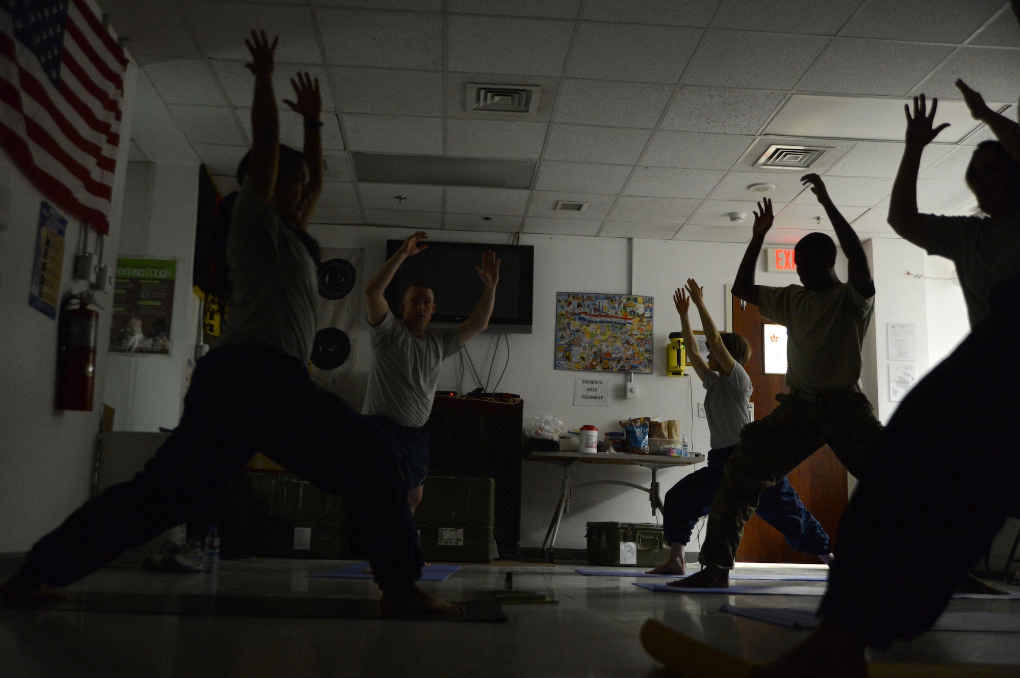 U.S. Air Force Senior Airman Kandie Ibarra, a lab technician assigned to the 455th Medical Support Squadron, Craig Joint Theater Hospital, Bagram Airfield, Afghanistan leads other healthcare professionals in the warrior I pose during yoga June 23, 2014.  Ibarra, a native of Blackfoot, Idaho is deployed form Keesler Air Force Base, Miss. (U.S. Air Force photo by Master Sgt. Cohen A. Young/Released)