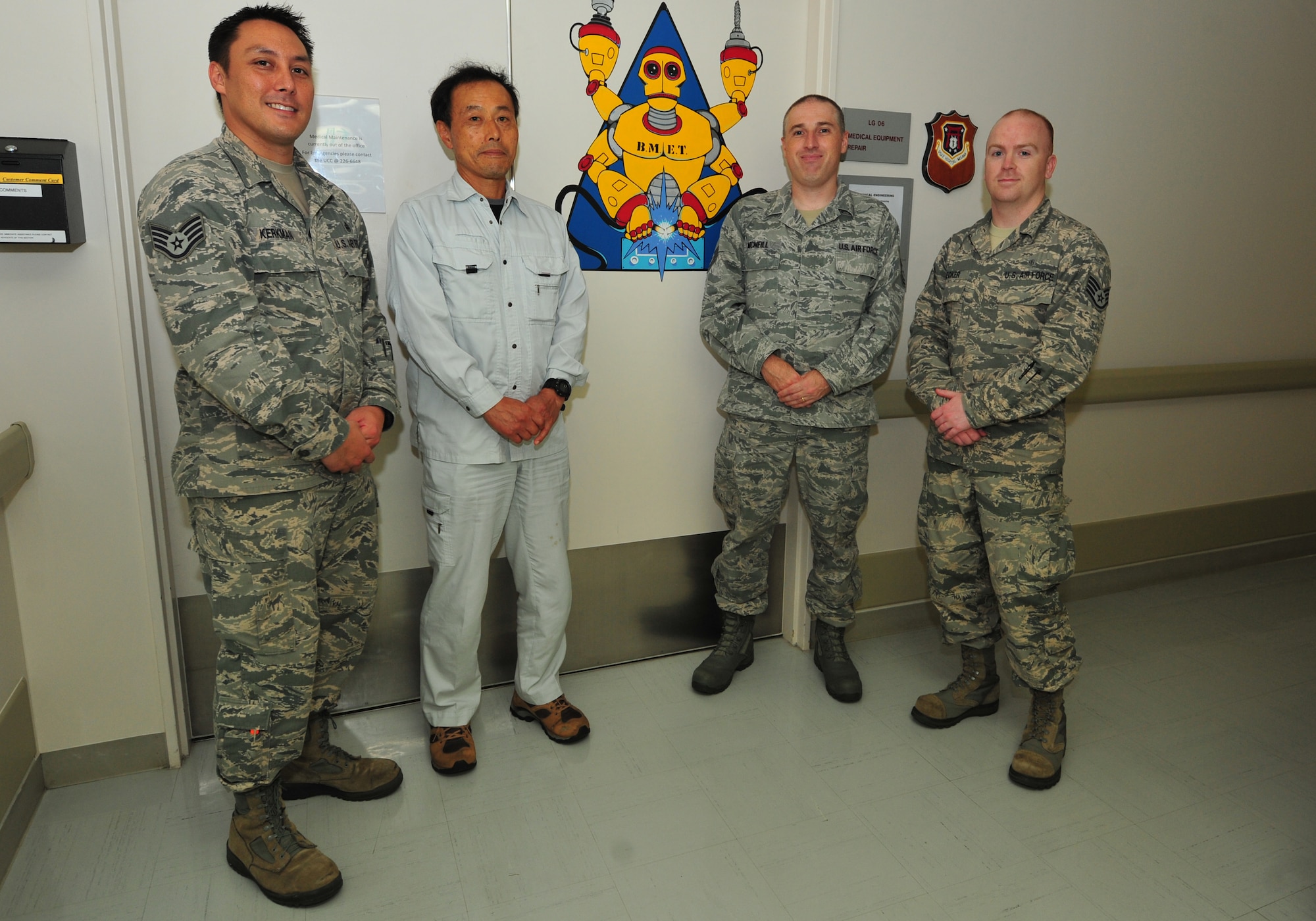 The Biomedical Equipment Technician team poses next to their signature design at Misawa Air Base, Japan, Aug. 1, 2014. Servicing more than $14 million in medical equipment each year, the team ensures providers have the necessary working tools to get their job done. (U.S. Air Force photo/Senior Airman Jose L. Hernandez-Domitilo)