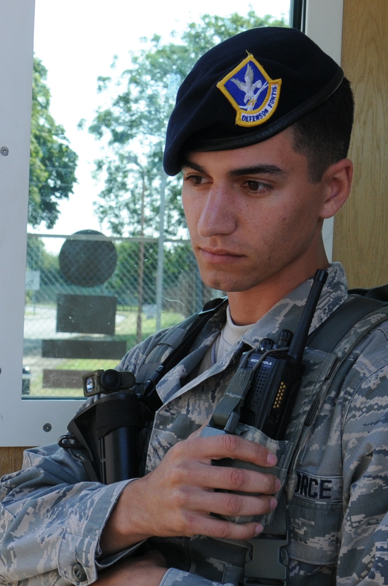 U.S. Air Force Airman 1st Class Tyler Reich, 100th Security Forces Squadron response force leader from Boston, uses a hand-held radio to listen to instructions from patrolmen on other base gates Aug. 4, 2014, on RAF Mildenhall, England. If there was a security issue on any part of the base, gates could need to be closed to incoming and outgoing users while the issue is resolved. (U.S. Air Force photo/Gina Randall/Released)