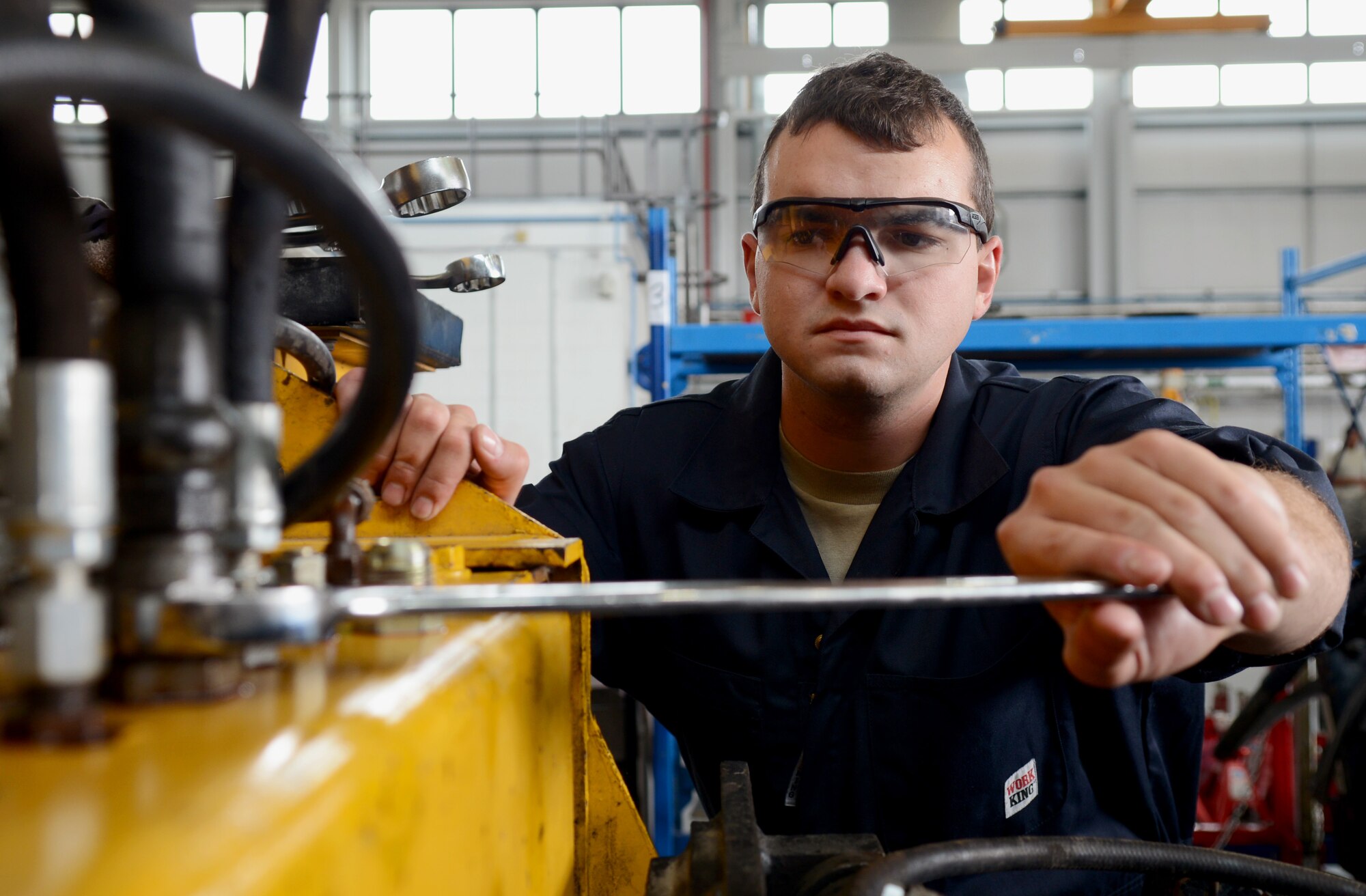 U.S. Air Force Senior Airman Steven Martin, 100th Logistics Readiness Squadron vehicle and equipment maintenance journeyman  from Hammond, La., attaches hydraulic lines for a snow broom head July 30, 2014, on RAF Mildenhall, England. Martin earned the Square D Spotlight for exhibiting the Air Force Core Value of Excellence in All We Do. (U.S. Air Force photo/Airman 1st Class Kyla Gifford/Released) 
