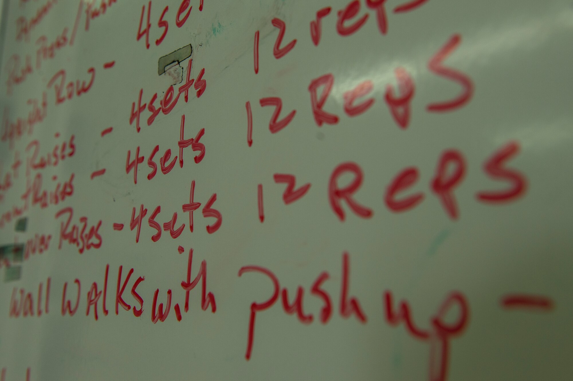 The workout of the day for a Bitburg High School summer strength training session is displayed on a dry erase board Aug. 8, 2014, at Spangdahlem Air Base, Germany. The sessions were held three times a week throughout the summer as a way for students to prepare for upcoming sports seasons. (U.S. Air Force photo by Senior Airman Rusty Frank/Released)