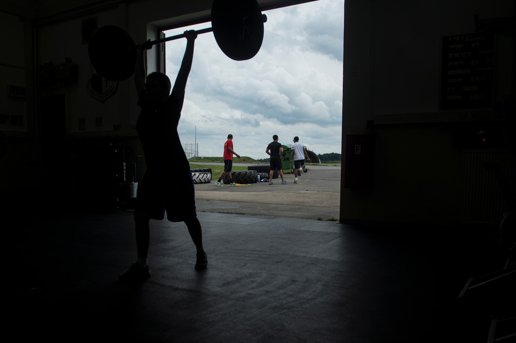 Bitburg High School students warm up prior to a workout during a Bitburg High School summer strength training session Aug. 8, 2014, at Spangdahlem Air Base, Germany. The sessions took place throughout the summer as a way for students to prepare for upcoming sports seasons.(U.S. Air Force photo by Senior Airman Rusty Frank/Released)