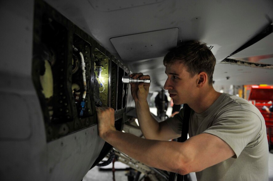 Senior Airman Dylan Gunter, 51st Maintenance Group electrical and environmental inspection team member, inspects the environmental control system service air lines for corrosion, dents and damage on Osan Air Base, Republic of Korea, Aug. 5, 2014. Gunter is this week’s Airman Spotlight winner. (U.S. Air Force photo/Senior Airman David Owsianka)