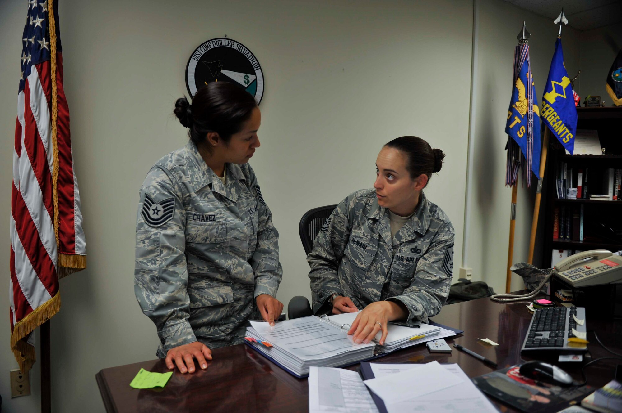 Master Sgt. Jessica McWain, 51st Fighter Wing Staff Agencies and Comptroller Squadron first sergeant, explains the process of taking emergency leave to Tech. Sgt. Alejandra Chavez, 51st FW Equal Opportunity NCO in charge, during a “Shadow the Shirt” day on Osan Air Base, Republic of Korea, Aug. 7, 2014. Six Airmen shadowed McWain during July and August to learn about a first sergeant’s duties. (U.S. Air Force photo/Senior Airman David Owsianka)