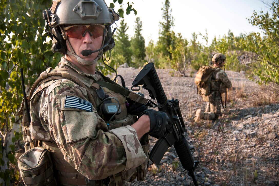 Air Force Capt. Daniel Curtin, foreground, looks back at his team as ...