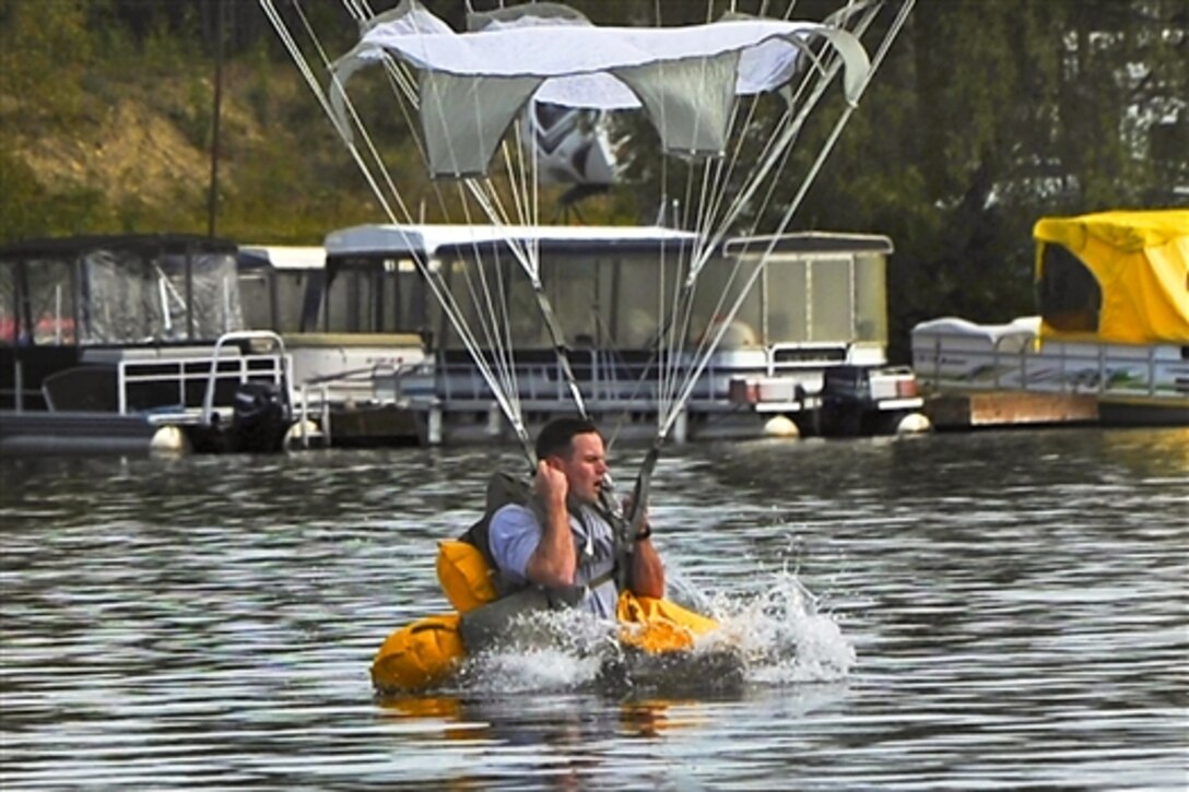 A paratrooper using a T-11 parachute makes a water landing in Big Lake, Alaska, Aug. 6, 2014. The training prepared the brigade's troopers for water landings and highlighted the unit's ability to perform airborne operations in challenging conditions and locations. 