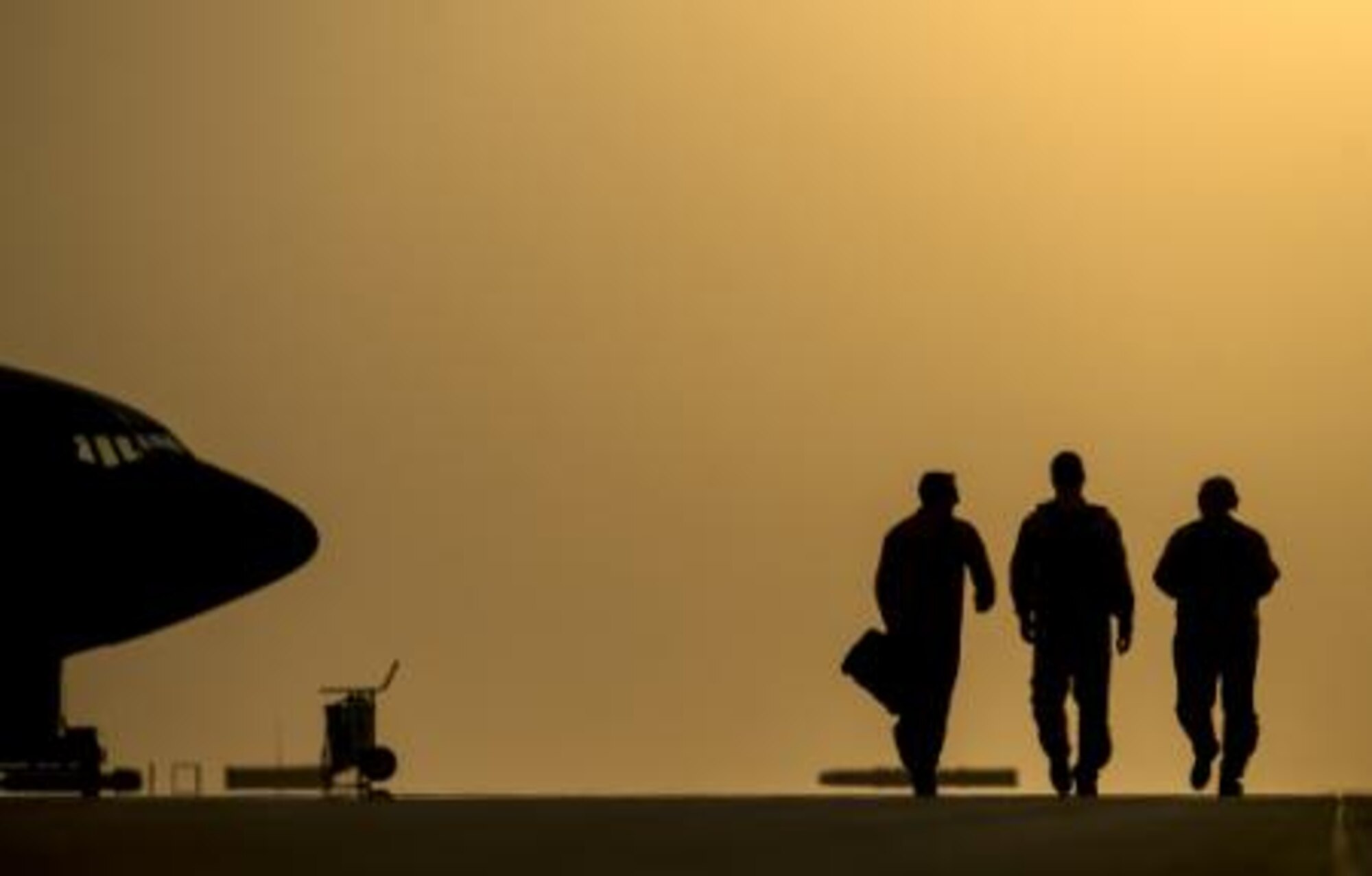 Capts. Andrea Delosreyes, Trent Parker and Airman 1st Class Kevin Haggith, 340th Expeditionary Air Refueling Squadron, KC-135 Stratotanker aircrew, step to their aircraft for an in-air refueling mission over Iraq, Aug. 11, 2014. The aircrew is scheduled to offload more than 40,000 gallons of fuel to Fighter Aircraft completing missions in Iraq. (U.S. Air Force photo by Staff Sgt. Vernon Young Jr.)