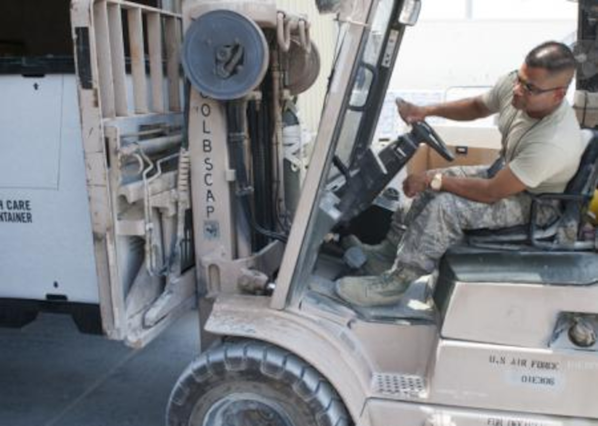 Tech. Sgt. Gautambhai Patel operates a forklift to help ready humanitarian aid pallets at a location in Southwest Asia Aug., 11, 2014. The pallets consist of food and water for humanitarian aid drops to assist displaced citizens in the vicinity of Sinjar, Iraq. (U.S. Air Force photo by Senior Airman Colin Cates)