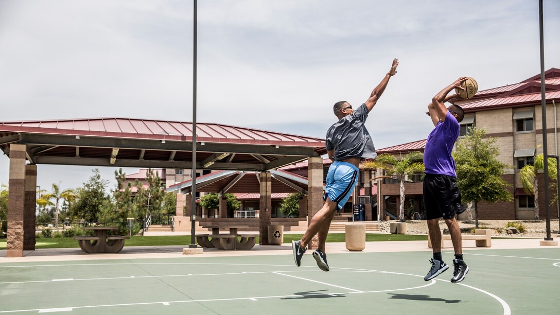 Sergeant Wayne Miller, left, defends Sgt. Kevin Santiago during a one-on-one basketball game aboard Camp Pendleton, Calif., July 29, 2014. Miller, 26, is from Orlando and is a Marine air-ground task force planner, and Santiago is a satellite communications operator, both with the 15th Marine Expeditionary Unit. (U.S. Marine Corps photo by Sgt. Emmanuel Ramos/Released)