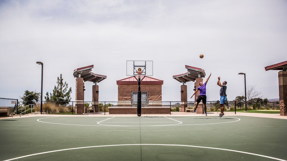 Sergeant Wayne Miller, right, shoots over Sgt. Kevin Santiago during a one-on-one basketball game aboard Camp Pendleton, Calif., July 29, 2014. Miller, 26, is from Orlando and is a Marine air-ground task force planner, and Santiago is a satellite communications operator, both with the 15th Marine Expeditionary Unit. (U.S. Marine Corps photo by Sgt. Emmanuel Ramos/Released)