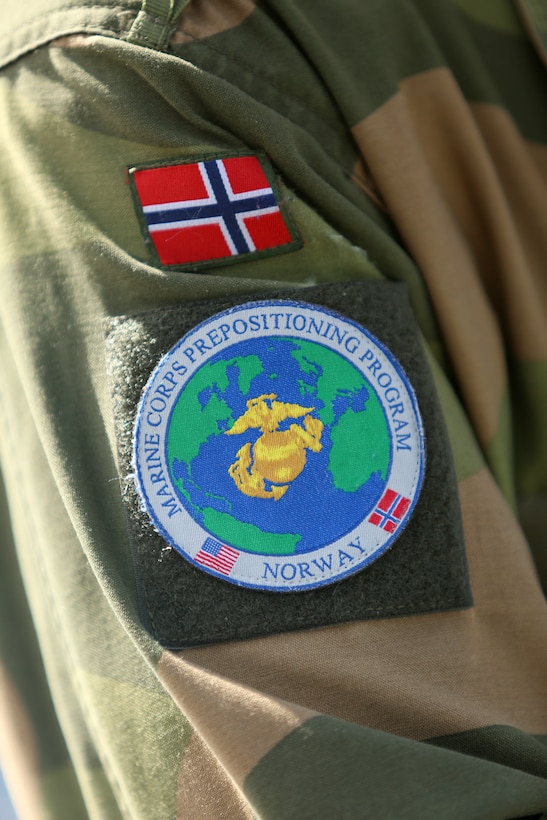 The patch worn by the Norwegian military members who are assigned to the Marine Corps Prepositioning Program-Norway clearly shows the partnership between the two countries.

U.S. Marines from 2nd Marine Logistics Group out of Camp Lejeune, NC, in coordination with their Norwegian counterparts, are modernizing some of the equipment currently stored within six caves as a part of the Marine Corps Prepositioning Program-Norway by placing approximately 350 containers of gear and nearly 400 pieces of heavy rolling stock into the storage caves.  