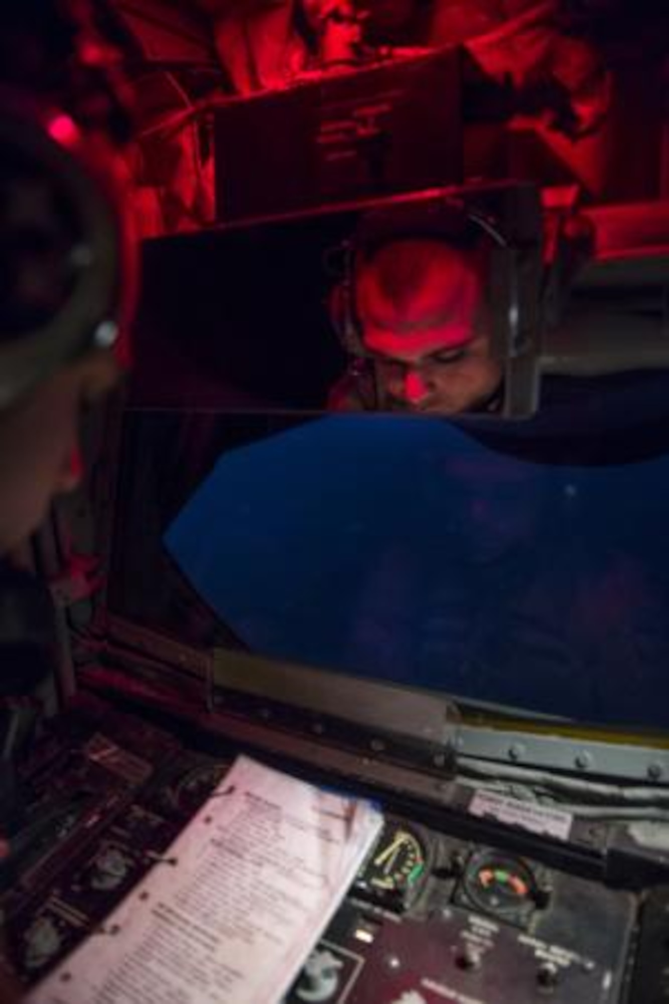 Airman 1st Class Kevin Haggith, 340th Expeditionary Air Refueling Squadron, KC-135 Stratotanker boom operator, reads through a boom operator checklist prior to providing fuel to an F-16 Fighting Falcon over Iraq, Aug. 12, 2014. As the boom operator for the mission, Haggith is responsible for assisting the aircraft commander, off-loading fuel to receivers, briefing passengers and recording the mission through computer devices. The aircrew off-loaded 40,000 gallons of fuel to Fighter Aircraft completing missions in Iraq. (U.S. Air Force photo by Staff Sgt. Vernon Young Jr.)