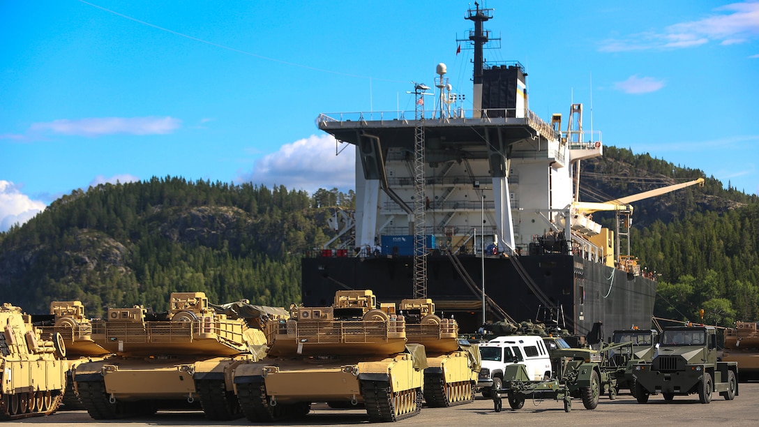 M1A1 Abrams Main Battle Tanks and other vehicles and equipment are staged for transportation at the designated offload pier during a pre-planned Single Ship Movement and offload of military equipment from a Maritime Prepositioning Force ship in the Trøndelag region of Norway. U.S. Marines from 2nd Marine Logistics Group out of Camp Lejeune, NC, in coordination with their Norwegian counterparts, are modernizing some of the equipment currently stored within six caves as a part of the Marine Corps Prepositioning Program-Norway by placing approximately 350 containers of gear and nearly 400 pieces of heavy rolling stock into the storage caves.    Specific equipment which will greatly increase the program’s readiness includes M1A1 Main Battle Tanks, Tank Retrievers, Armored Breeching Vehicles, Amphibious Assault Vehicles, Expanded Capacity Vehicle (ECV) Gun Trucks and several variants of the MTVR 7 ½ ton trucks. Planning for this equipment refresh began in the spring of 2010. 