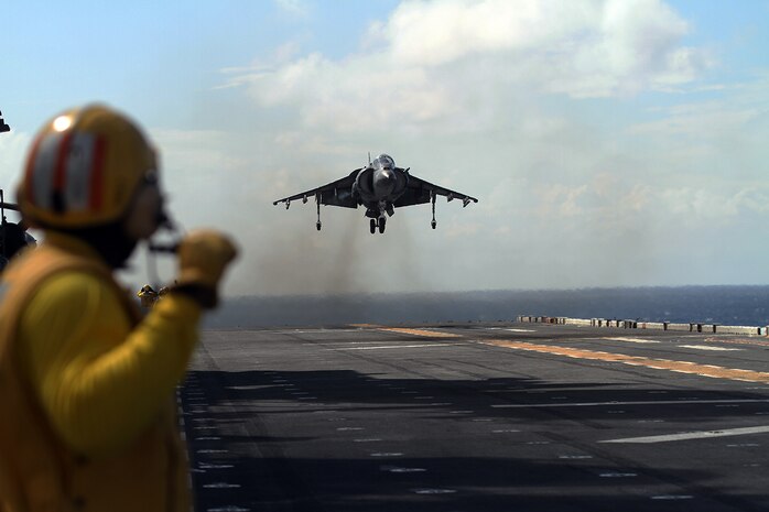 An AV-8B Harrier Jump Jet from Marine Medium Tiltrotor Squadron 365 (Reinforced), 24th Marine Expeditionary Unit, prepares to land on the USS Iwo Jima off the coast of North Carolina, Aug. 11, 2014. The 24th MEU is taking part in Amphibious Squadron/Marine Expeditionary Unit Integration, or PMINT, the 24th MEU’s second major pre-deployment training exercise. PMINT is designed to bring Marines and Sailors from the 24th MEU and Amphibious Squadron 8 together for the first time aboard the ships of the Iwo Jima Amphibious Ready Group. (U.S. Marine Corps photo by Lance Cpl. Dani A. Zunun)