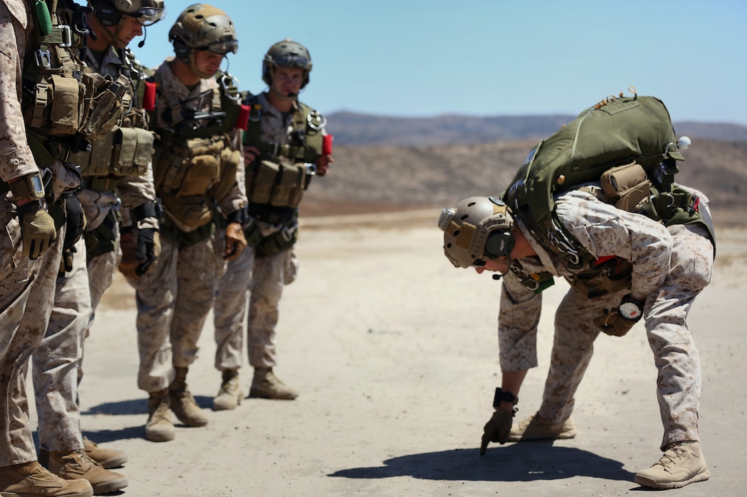 Marines with Company B, 1st Reconnaissance Battalion, 1st Marine Division, I Marine Expeditionary Force go over jump procedures before conducting proficiency jump training aboard Marine Corps Base Camp Pendleton California, Aug. 6, 2014 in preparation to deploy with the 15th Marine Expeditionary Unit, I MEF. The Marines conducted static line jumps and several free fall jumps throughout the day. 