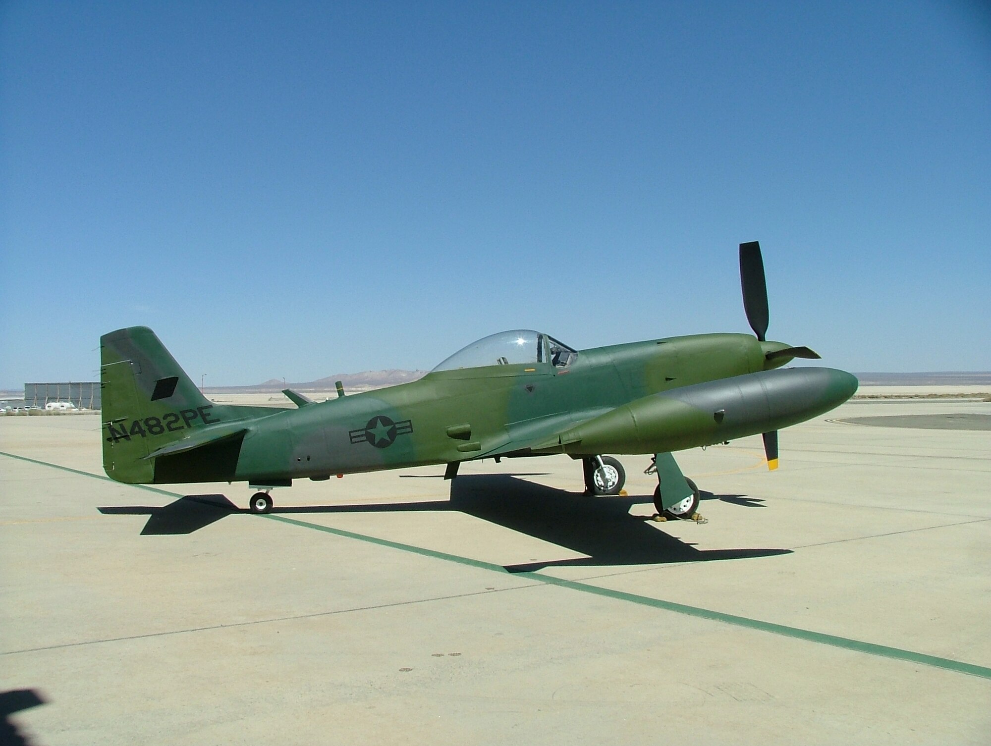 Photo of a Piper PA-48 Enforcer in front of the Air Force Flight Test Museum hangar at Edwards Air Force Base, Calif., after the aircraft was restored and repainted. (U.S. Air Force photo by Tony Moore)