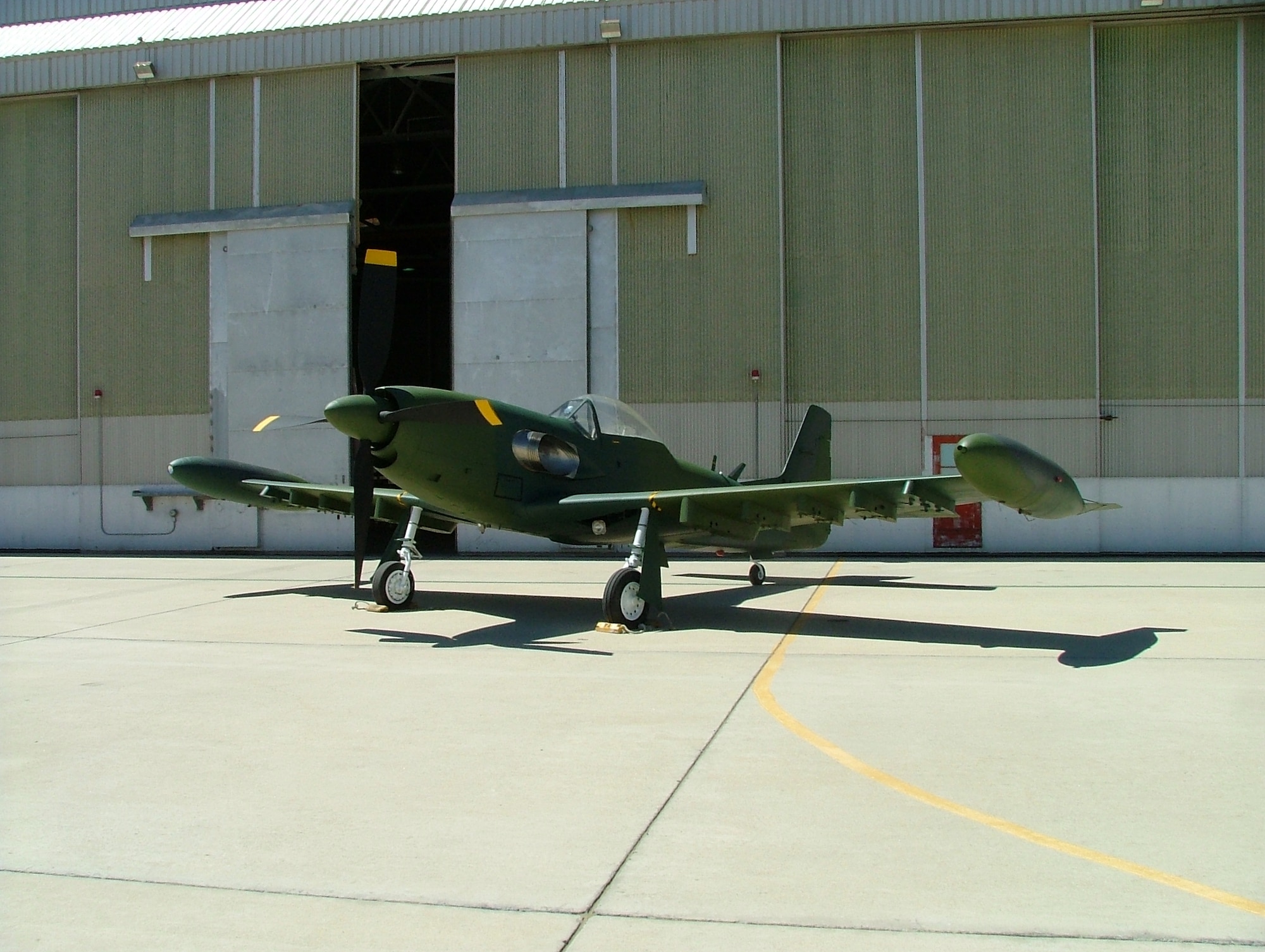 Photo of a Piper PA-48 Enforcer in front of the Air Force Flight Test Museum hangar at Edwards Air Force Base, Calif., after the aircraft was restored and repainted. (U.S. Air Force photo by Tony Moore)