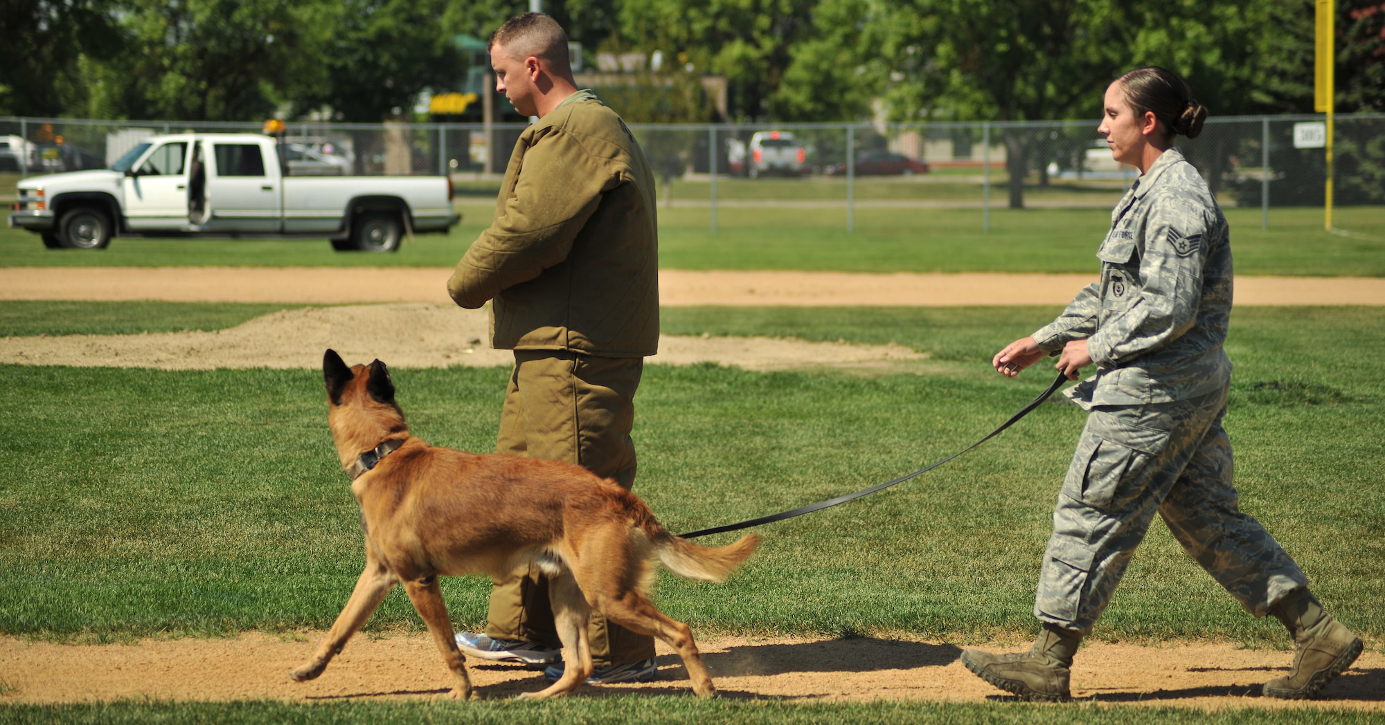 Military Working Dog T-Rex, paces and keeps a close eye for any sudden movement from a pretend aggressor, as her handler, Staff Sgt. Jessica Newton, 319th Security Forces Squadron, walks him during the patrol maneuvers portion of the North Dakota Peace Officers Association’s K9 Challenge held Aug. 13, 2014, at Apollo Park in the city of Grand Forks, N.D. Newton and T-Rex placed first in the patrol maneuvers portion of the competition. (U.S. Air Force photo/Senior Airman Xavier Navarro)