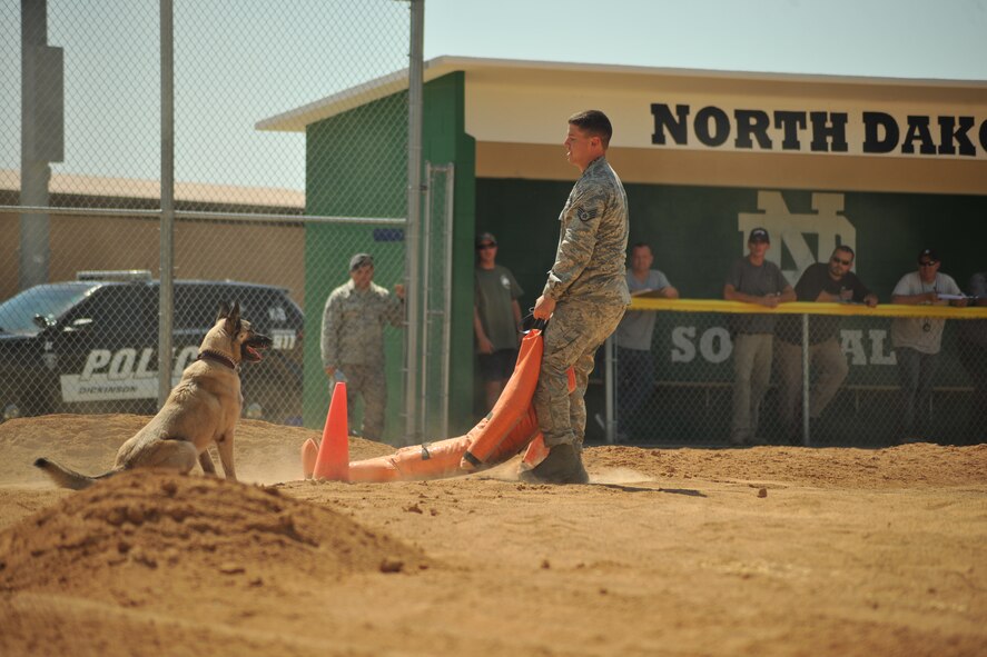 Staff Sgt. Brett Silmon, 319th Security Forces Squadron military working dog handler, drags a rescue dummy during the officer rescue portion of the Iron Dog Course on Apollo Park on Aug. 13, 2014 in Grand Forks, N.D. Officer rescue course represents having to pull a victim from danger while the K9 stays from where its told. The Iron Dog Course was one of three competitions featured during the North Dakota Peace Officers Association’s K9 Challenge. (U.S. Air Force photo/Senior Airman Xavier Navarro) 