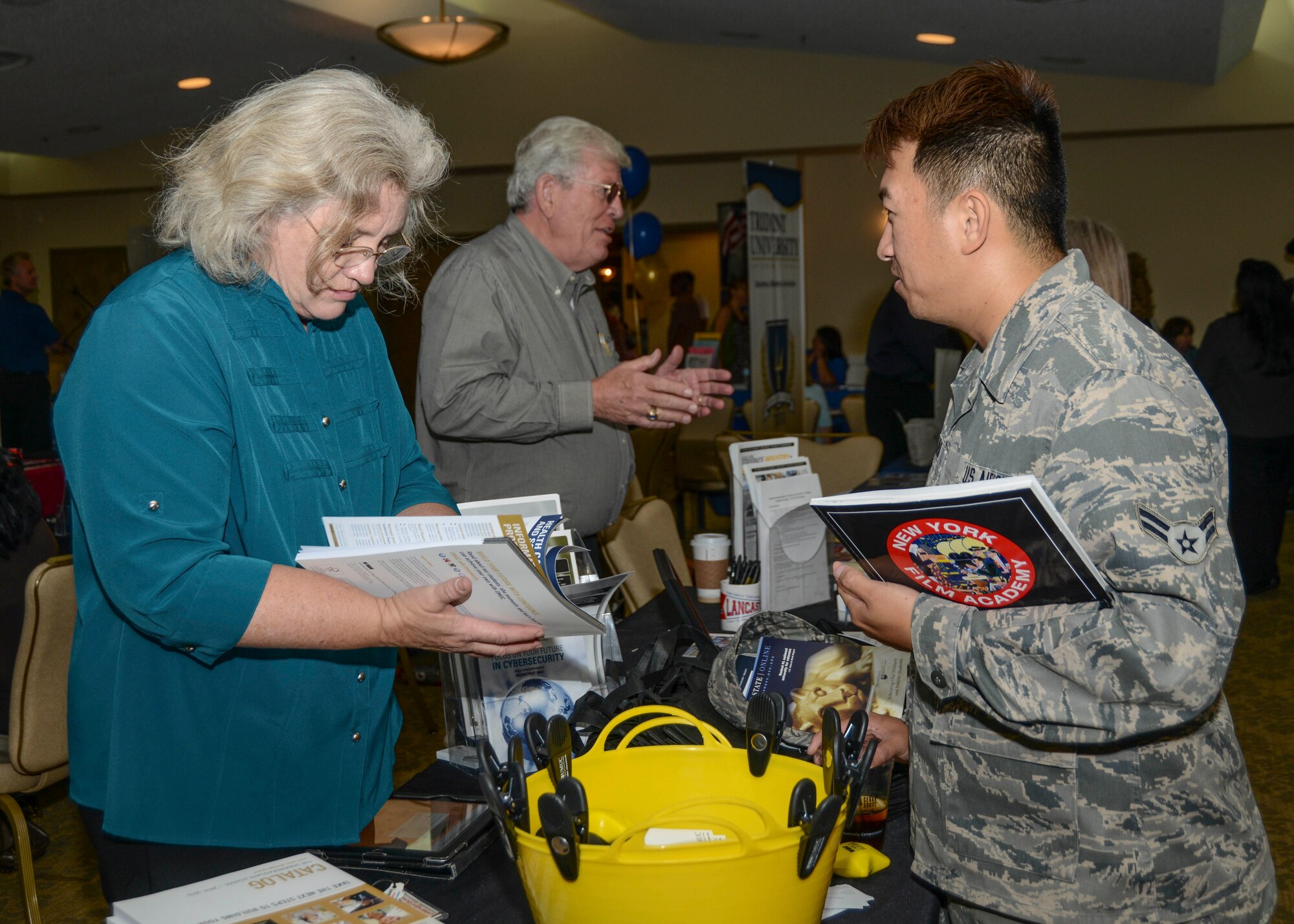 Renetta Watts, University of Maryland Advanced Military Education coordinator, shares school brochures at the annual Education Fair Aug. 13. Watts represented one of 59 schools at the fair that ran from 10 a.m. to 1 p.m. at Club Muroc.  (U.S. Air Force photo by Rebecca Amber)