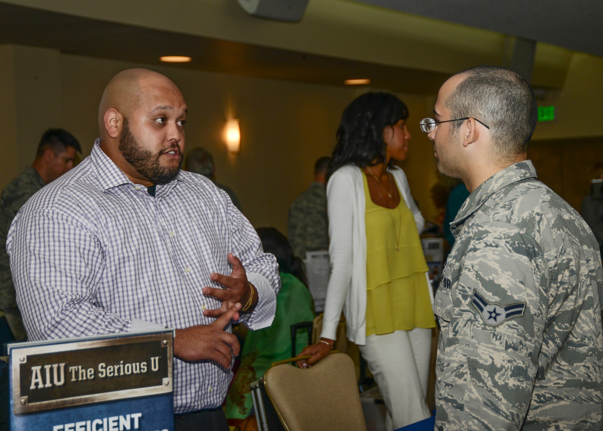 Ivan Hernandez, American Intercontinental University Military Relations manager, counsels an Airman about his educational options at their university. (U.S. Air Force photo by Rebecca Amber) 