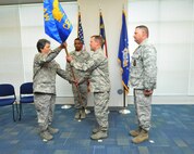 U.S. Air Force Col. Barbara G. Doncaster, 145th Mission Support Group commander passes the guidon to Lt. Col. Milton J. Addison as he accepts and assumes command of the 145th Civil Engineer Squadron during a Change of Command ceremony held at the North Carolina Air National Guard base, Charlotte Douglas Intl. airport, June 7, 2014. The traditional handing over of the guidon signifies the relief and acceptance of duty between two individuals. It also allows for the accepting commander to be welcomed by his troops, as well as the departing commander Lt. Col. Gregory J. Walters to give lasting remarks and farewells. (U.S. Air National Guard photo by Master Sgt. Patricia F. Moran, 145th Public Affairs/Released) 