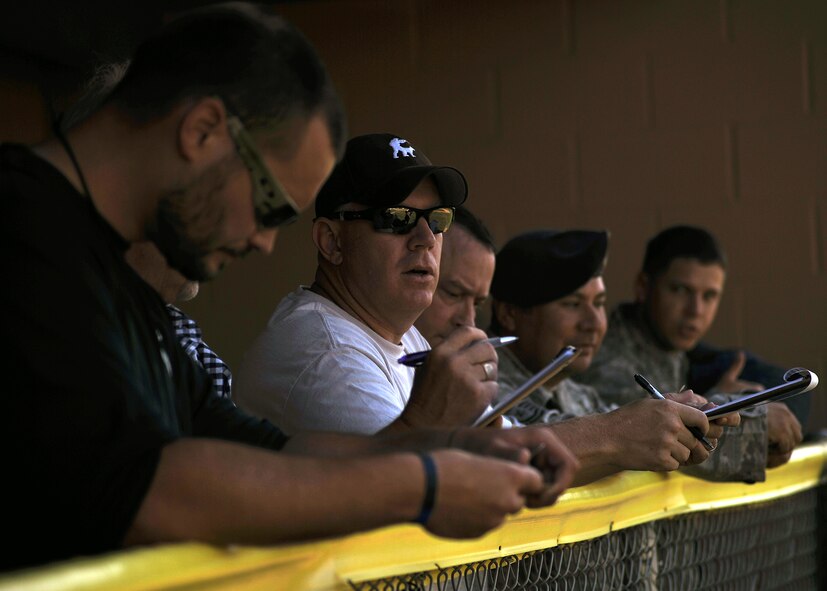 Judges keep tally based on a set criteria during the North Dakota Peace Officers Association’s K9 Challengea held Aug. 13, 2014, at Apollo Park, in the city of Grand Forks, N.D. Judges add and deduct points during the competition while they look for physical conditioning, obedience training and how fast the K9 teams complete the course. (U.S. Air Force photo/Senior Airman Xavier Navarro)