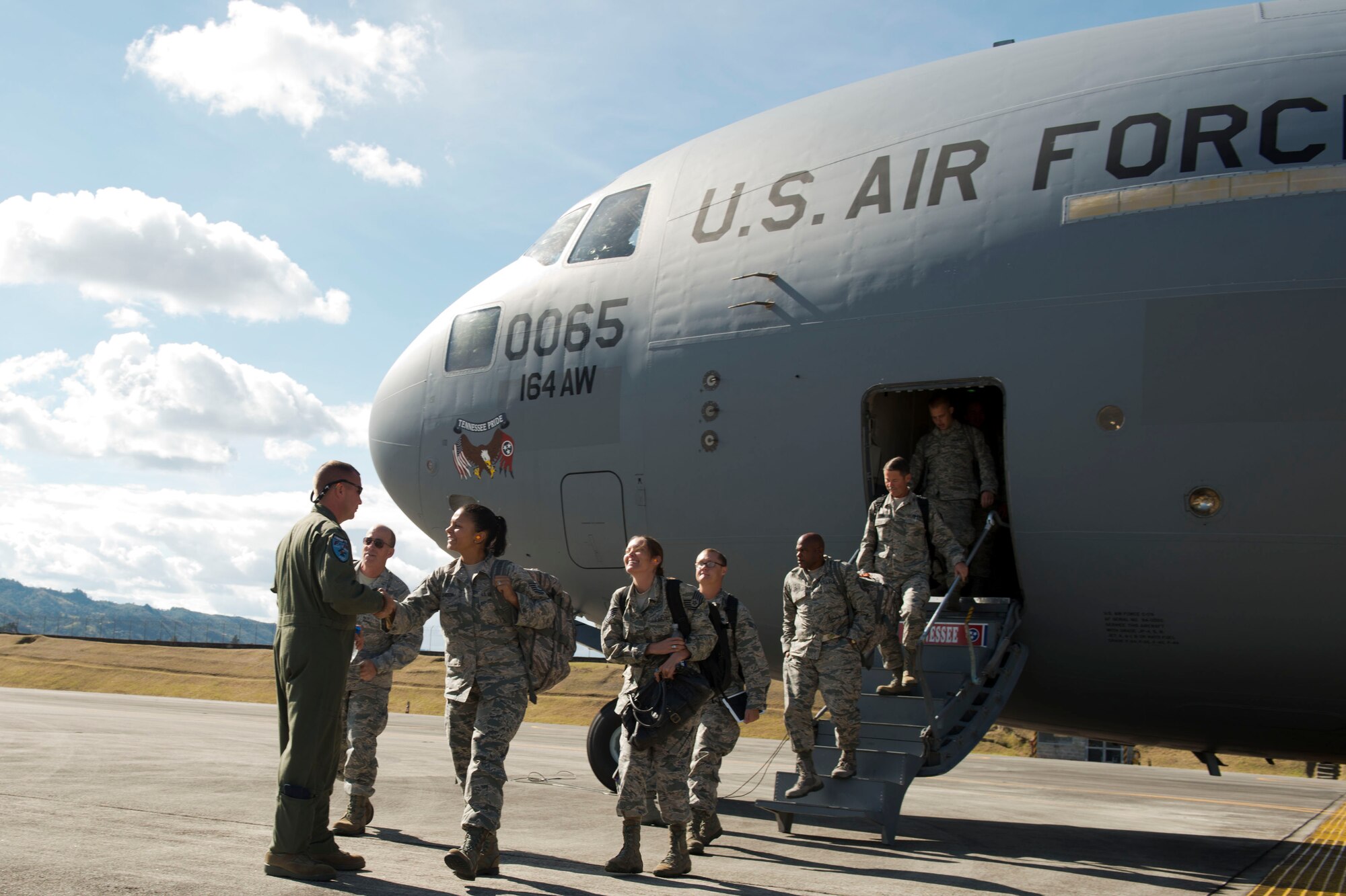 U.S. Airmen, assigned to the 169th Fighter Wing from McEntire Joint National Guard Base of the South Carolina Air National Guard, disembark from a C-17 Globemaster III, from the Tennessee Air National Guard, Aug. 9, 2014, at Rionegro, Colombia during Relampago (Lightning) 2014. Relampago is a combined air cooperation engagement with the Republic of Colombia. One hundred Airmen and six F-16s are participating in the first major joint-air training opportunity under the auspices of the South Carolina National Guard's State Partnership Program with the country of Colombia. (U.S. Air National Guard photo by Tech. Sgt. Jorge Intriago/Released)