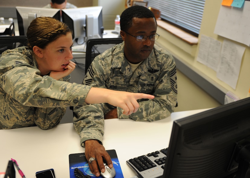 U.S. Air Force Chief Master Sgt. Eddie Webb, 7th Bomb Wing command chief, looks over performance reports with Airman 1st Class Caitlynn White, 7th Force Support Squadron force management technician, June 24, 2014, at Dyess Air Force Base, Texas. Webb spent the day learning from White how to close out enlisted and officer performance reports as part of his monthly “Teach the Chief” program. (U.S. Air Force photo by Airman 1st Class Alexander Guerrero/Released)