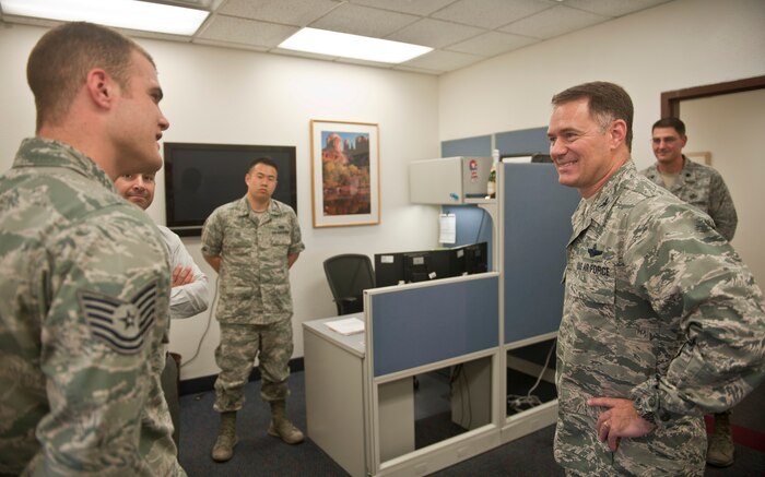 Col. Richard Boutwell, 99th Air Base Wing commander, shares a story with a member of the 99th Contracting Squadron during Boutwell’s immersion with the unit at Nellis Air Force Base, Nev., Aug. 12, 2014. Boutwell visited the 99th CONS to gain a better understanding of how the unit affects operations at Nellis and to meet the men and women who make up the squadron. The new commander said meeting the people throughout the installation is what he is looking forward to the most during his tenure as commander here. (U.S. Air Force photo by Staff Sgt. Siuta B. Ika)