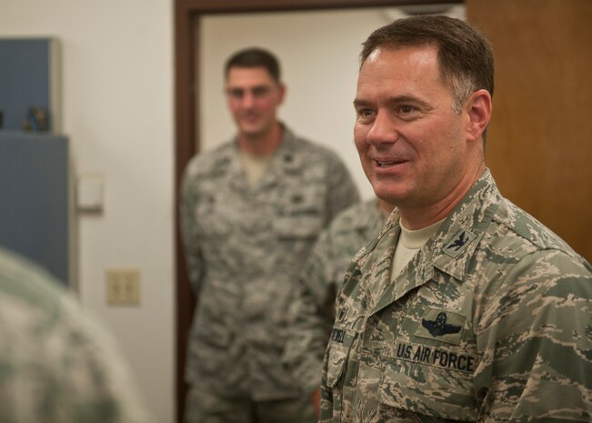 Col. Richard Boutwell, 99th Air Base Wing commander, shares a story with a member of the 99th Contracting Squadron during his unit immersion at Nellis Air Force Base, Nev., Aug. 12, 2014. Boutwell, who is a command pilot with more than 3,500 flying hours, once served as a U.S. Air Force Thunderbirds pilot and hopes to be thought of as a servant-leader during his time in command here. (U.S. Air Force photo by Staff Sgt. Siuta B. Ika)