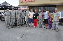Members of the 442d Fighter Wing, founder of the Cars 4 Heroes organization Terry "Car Santa" Franz and family members of Senior Airman Thelma Smith stand next to the 2001 Ford Explorer that was donated to her by Cars 4 Heroes at an event held at the Bi-Lo Country Mart in Warrensburg, Mo., Friday. (U.S. Air Force photo by 1st Lt. Jeff Kelly/Released)