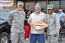 Terry "Car Santa" Franz, founder of the Cars 4 Heroes organization is given a token of appreciation on behalf of the men and women of the 442d Fighter Wing by 442 FW Interim Mission Support Group Commander, Lt Col Constance Johnson-Cage and Senior Master Sergeant Travis Stickels, 442 FW Services Squadron Superintendent at an event held at the Bi-Lo Country Mart in Warrensburg, Mo., Friday. (U.S. Air Force photo by 1st Lt. Jeff Kelly/Released)