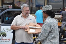 Terry "Car Santa" Franz, founder of the Cars 4 Heroes organization is given a token of appreciation on behalf of the men and women of the 442d Fighter Wing by 442 FW Interim Mission Support Group Commander, Lt Col Constance Johnson-Cage at an event held at the Bi-Lo Country Mart in Warrensburg, Mo., Friday. (U.S. Air Force photo by 1st Lt. Jeff Kelly/Released)