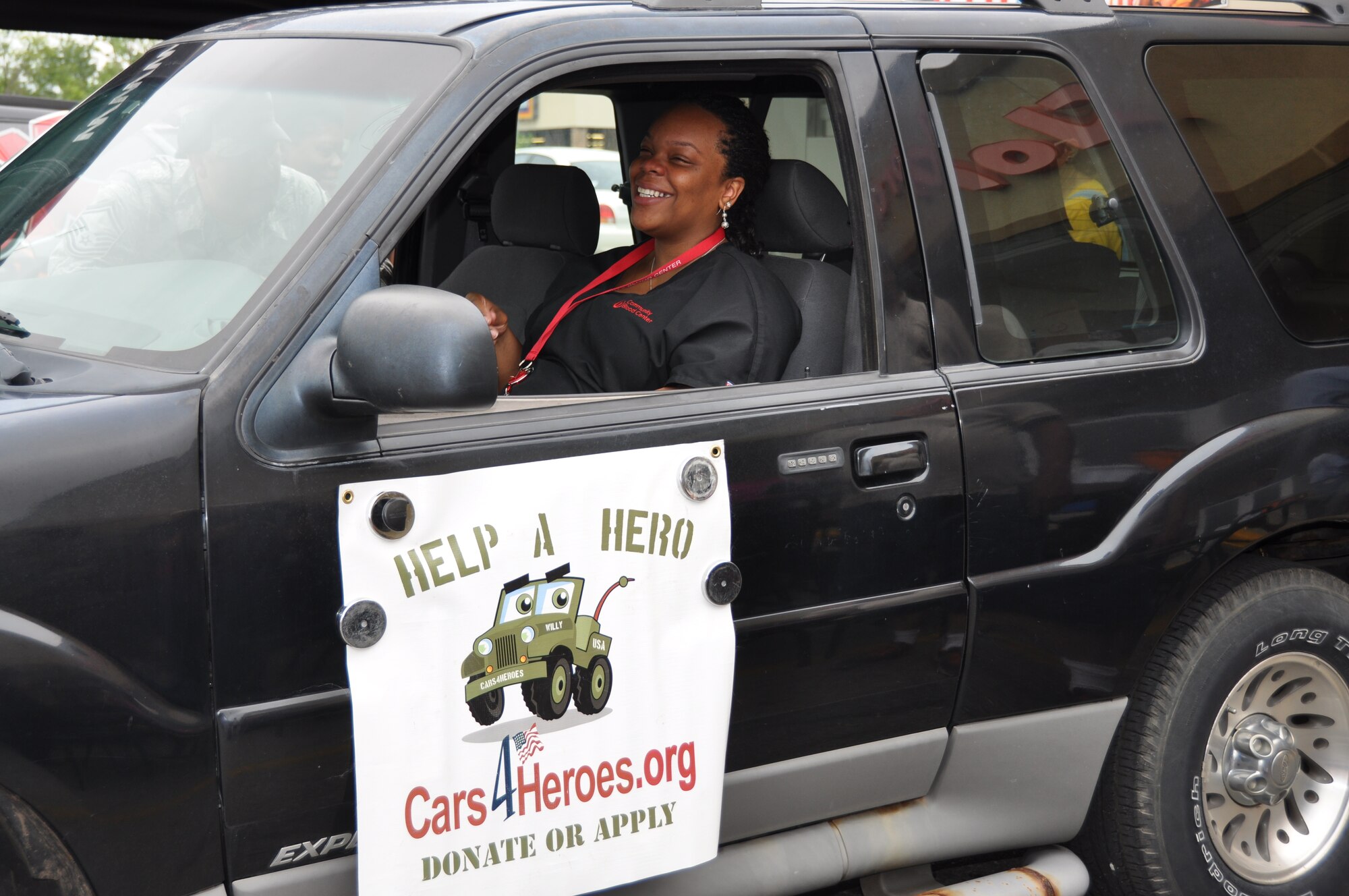 Senior Airman Thelma Smith sits in her 2001 Ford Explorer for the first time after receiving it from the Cars 4 Heroes organization at an event held at the Bi-Lo Country Mart in Warrensburg, Mo., Friday. (U.S. Air Force photo by 1st Lt. Jeff Kelly/Released)