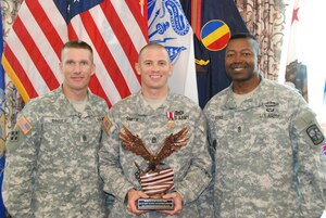 U.S. Army Training and Doctrine Command's 2014 Noncommissioned Officer of the Year, Sgt. 1st Class David Smith, representing U.S. Army Cadet Command, Fort Knox, Ky., is recognized by Command Sgts. Maj. Daniel Dailey, TRADOC command sergeant major, and Odell Ford Jr., University of North Georgia's Department of Military Science command sergeant major,  following the competition at Fort Eustis, Va., Aug. 6, 2014. Smith is a military science instructor at the University of North Georgia, 1st Brigade, Cadet Command. (U.S. Army photo by Sgt. 1st Class Lisa Nicolas/Released)