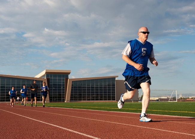 Tech. Sgt. Brian Mowry, 57th Maintenance Squadron NCO in charge of munitions inventory, completes the 1.5-mile timed run portion of the Air Force fitness assessment test at the Warrior Fitness Center, Nellis Air Force Base, Nev., Aug. 12, 2014. The faster an Airman completes the run, the higher score they will receive. (U.S. Air Force photo by Airman 1st Class Thomas Spangler)
