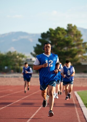 Staff Sgt. Michael Watlington, U.S. Air Force Warfare Center command chief executive assistant, finishes his first lap of the 1.5-mile run portion of the Air Force fitness assessment at the Warrior Fitness Center, Nellis Air Force Base, Nev., Aug. 12, 2014. The running portion of the assessment is designed to test service members’ cardiovascular strength and endurance. (U.S. Air Force photo by Airman 1st Class Thomas Spangler)