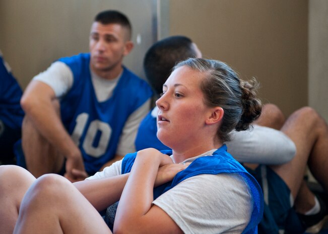 Staff Sgt. Madison Carroll, U.S. Air Force Thunderbirds non-destructive inspector, completes the sit-ups portion of the Air Force fitness assessment test at the Warrior Fitness Center, Nellis Air Force Base, Nev., Aug. 12, 2014. The sit-ups portion of the test is meant to test core and abdominal strength. (U.S. Air Force photo by Airman 1st Class Thomas Spangler)