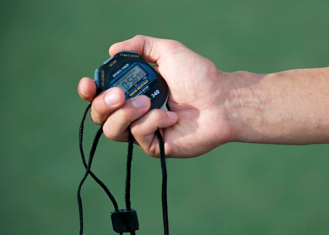 Senior Airman Robert Taylor, 99th Logistics and Readiness Squadron supply journeyman, keeps track of times during the running portion of the Air Force fitness assessment at the Warrior Fitness Center, Nellis Air Force Base, Nev., Aug. 11, 2014. The running portion of the test is a timed 1.5-mile run meant to test cardiovascular strength and endurance. Many Airmen have seen their run times improve after participating in the Health and Wellness Center’s six week running program, designed not only to improve running performance, but overall wellness. (U.S. Air Force photo by Airman 1st Class Thomas Spangler)