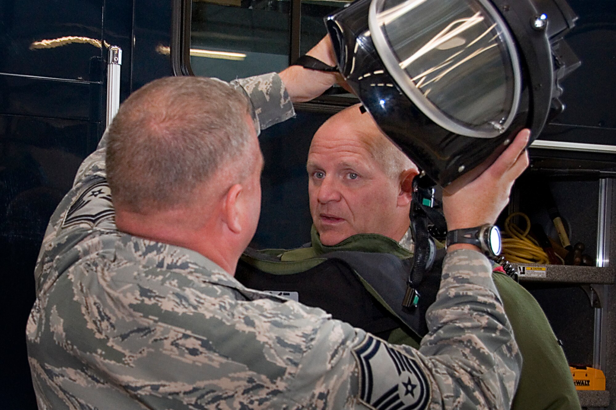 GRISSOM AIR RESERVE BASE, Ind. -- Senior Master Sgt. Scott Fleek, 434th Civil Engineer Squadron explosives ordnance disposal flight superintendent, helps Col. Mark Pantone, 4th Air Force director of logistics and instaillations, put on a bomb suit helmet during the colonel?s visit to Grissom Air Reserve Base, Ind., Aug. 10, 2014. Visits from 4th AF are periodically conducted to get an in-depth look into issues affecting wing missions, giving leadership an ability to advocate for solutions to those issues. (U.S. Air Force photo/Staff Sgt. Ben Mota)