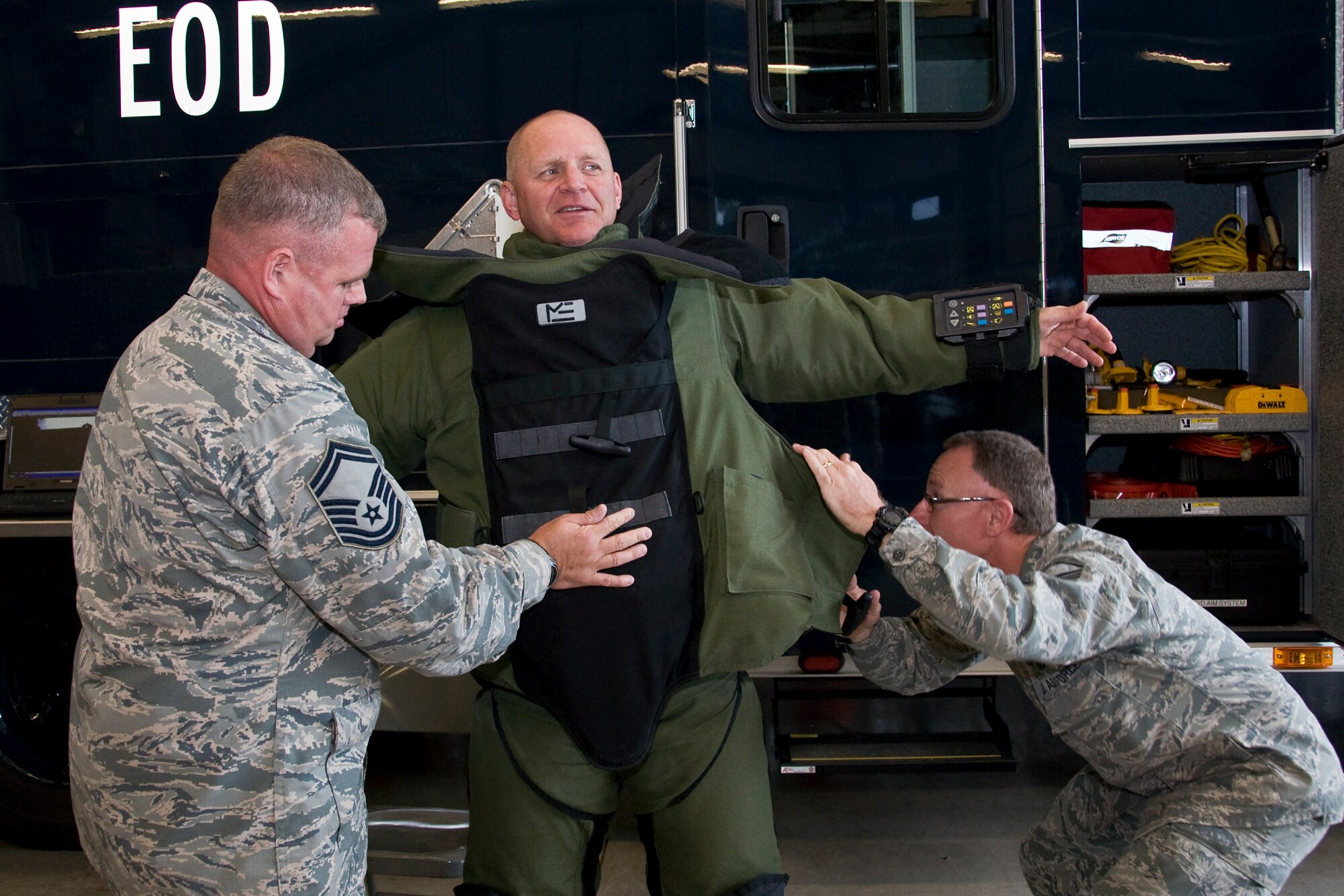 GRISSOM AIR RESERVE BASE, Ind. -- Senior Master Sgt. Scott Fleek, 434th Civil Engineer Squadron explosives ordnance disposal flight superintendent, left, and Master Sgt. Charles Lyon, 434th CES EOD noncommissioned officer in charge, right, help Col. Mark Pantone, 4th Air Force director of logistics and installations, into a bomb suit during the colonel?s visit to Grissom Air Reserve Base, Ind., Aug. 10, 2014. During the two-day visit, Pantone met with Airmen across the wing to discuss issues and identify opportunities and challenges affecting the wing. (U.S. Air Force photo/Staff Sgt. Ben Mota)