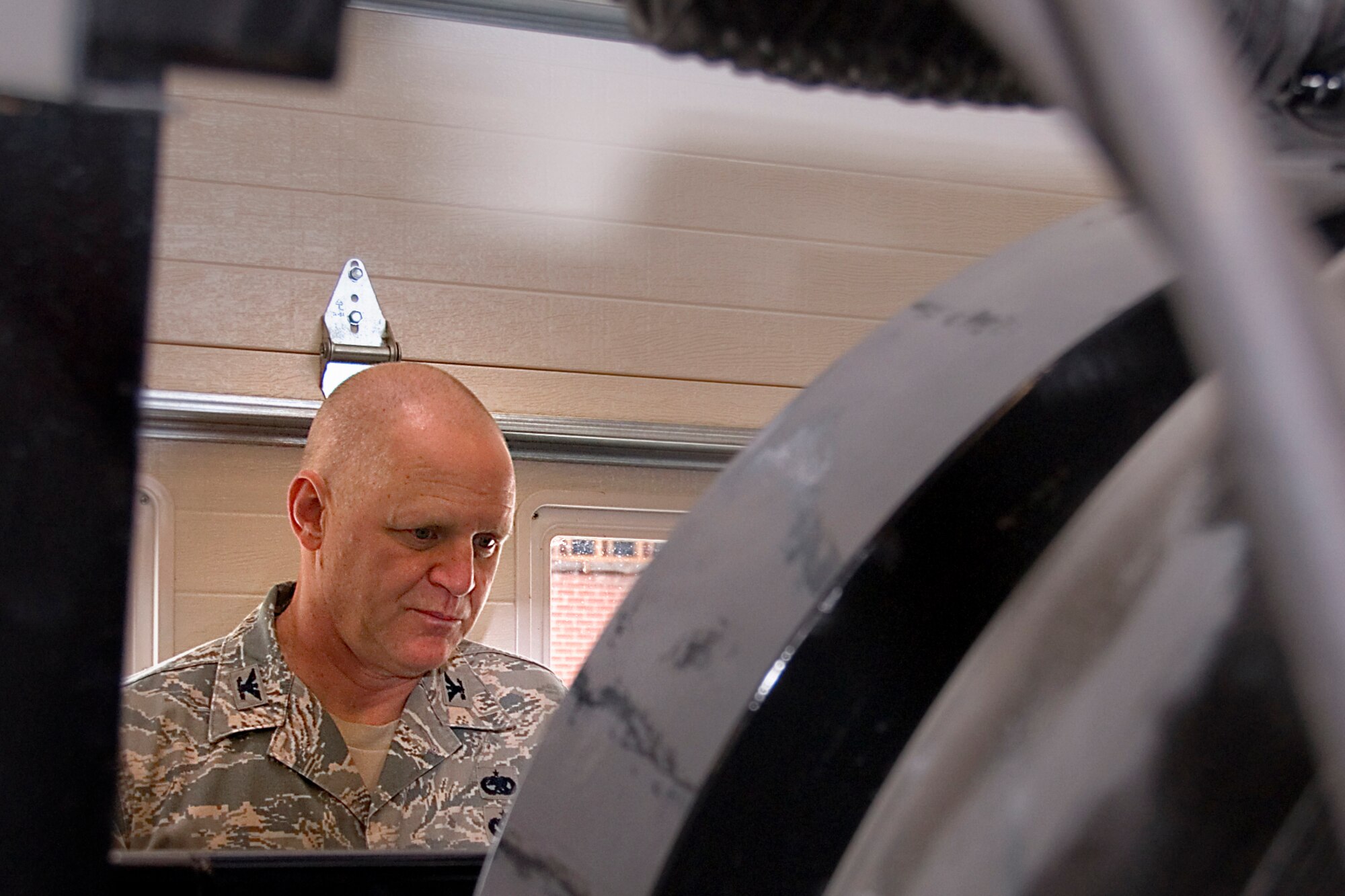 GRISSOM AIR RESERVE BASE, Ind. -- Col. Mark Pantone, 4th Air Force director of logistics and installations, looks into an explosives ordnance total containment vessel during the colonel?s visit to Grissom Air Reserve Base, Ind., Aug. 10, 2014. During the two-day visit, Pantone met with Airmen across the wing to discuss issues and identify opportunities and challenges affecting the wing. (U.S. Air Force photo/Staff Sgt. Ben Mota)