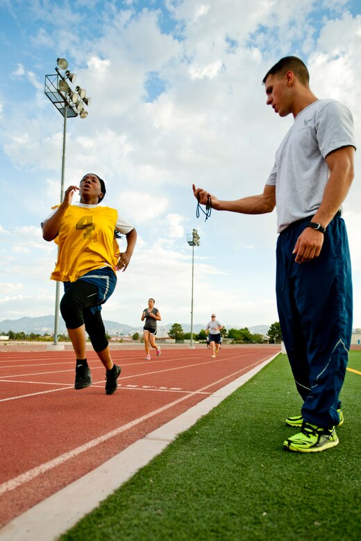 Senior Airman Ahlavatuah Garrett-Johnson, 99th Security Forces Squadron installation entry controller journeyman, finishes her Air Force fitness assessment at Nellis Air Force Base, Nev. Aug. 11, 2014. Garrett-Johnson’s assessment was conducted just days after finishing the 99th Aerospace Medicine Squadron Health and Wellness Center’s six-week running program. Her final run time was more than four minutes faster than before she went through the program. (U.S. Air Force photo by Senior Airman Timothy Young)