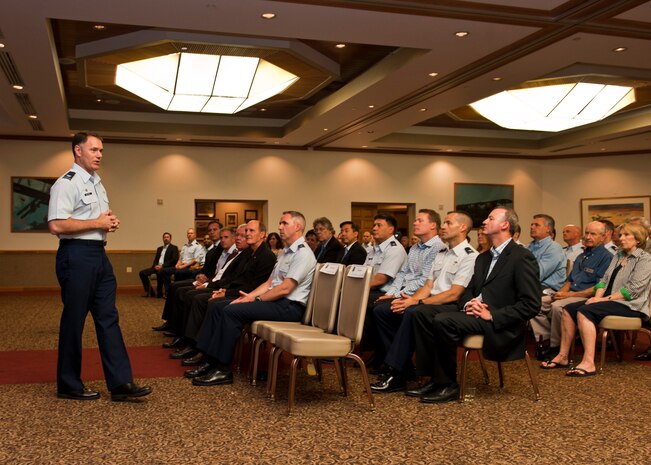 Col. Richard Boutwell, 99th Air Base Wing commander, speaks to attendees of the Honorary Commander Induction Ceremony at Nellis Air Force Base, Nev., Aug. 7, 2014. The goal of the honorary commander program is to acquaint community leaders with the missions here at Nellis, Creech and the Nevada Test and Training Range. (U.S. Air Force photo by Senior Airman Jason Couillard)